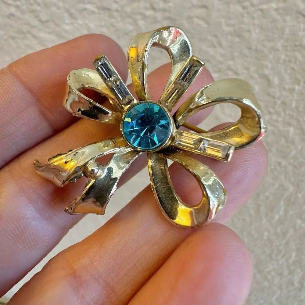Coro vintage gold tone and blue rhinestone bow brooch